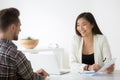 Friendly asian hr smiling talking to candidate at job interview Royalty Free Stock Photo