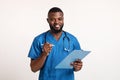 Friendly black doctor taking patients history, white background