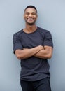 Friendly black man smiling with arms crossed