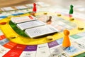 A friendly board game spread out on a table in the room. Gameplay in progress
