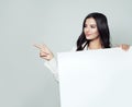 Friendly business woman pointing her finger and showing board Royalty Free Stock Photo