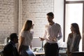 Friendly businessman joking with diverse colleagues during break Royalty Free Stock Photo