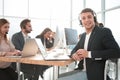 Friendly call center operator sitting at his Desk. Royalty Free Stock Photo