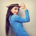 Friendly casual woman in blue top and straw hat looking. Vintage