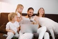 Friendly caucasian family at home with laptop Royalty Free Stock Photo