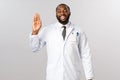 Friendly cheerful african-american doctor inviting patients for check-up, greeting people with optimistic joyful smile