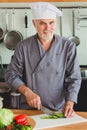 Friendly chef preparing vegetables in his kitchen