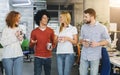 Friendly colleagues enjoying coffee in modern office