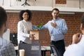 Friendly company ceo welcoming african employee in multiracial o Royalty Free Stock Photo