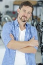 Friendly and competent bicycle mechanic in workshop posing Royalty Free Stock Photo