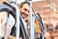 Friendly and competent bicycle mechanic in a workshop repairs a bike Royalty Free Stock Photo