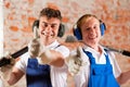 Friendly construction workers with thumps up Royalty Free Stock Photo