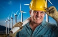 Friendly Contractor in Hard Hat Holding Extension Cord By Turbines