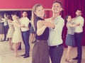 Friendly dancing couples enjoying foxtrot