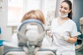 Friendly dentist woman treating patient
