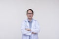 A friendly doctor of asian descent, middle aged male in his 40s with arms crossed. Isolated on a white background Royalty Free Stock Photo