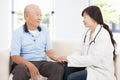 Friendly doctor caring senior man indoor room