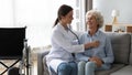 Friendly doctor listening to older woman lung or heart sound Royalty Free Stock Photo