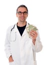 Friendly doctor with money and piggybank Royalty Free Stock Photo