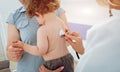 Friendly doctor pediatrician with patient child at clinic