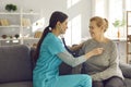 Friendly doctor with stethoscope examining happy senior patient& x27;s heart and lungs Royalty Free Stock Photo