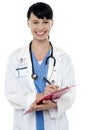 Friendly doctor updating medical record Royalty Free Stock Photo