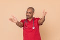 Friendly doctor wearing red uniform Royalty Free Stock Photo