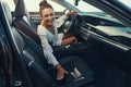 Woman inviting a person to have a seat in car Royalty Free Stock Photo