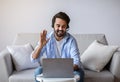 Friendly Eastern Man Making Video Call With Laptop And Headset At Home Royalty Free Stock Photo
