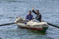 Friendly Egyptian men row their boat on the River Nile near Edfu in Egypt.