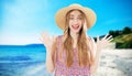 Friendly emotional beautiful girl in a summer hat on vacation on the beach of the sea. Maldives or Hawaii travel Royalty Free Stock Photo