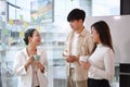 Friendly executive business leader having discussion with young employees at coffee break in office Royalty Free Stock Photo