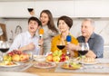 Friendly family with adult children singing karaoke together Royalty Free Stock Photo
