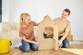 Friendly family and kid boy playing in new home with cardboard boxes on floor. Portrait Royalty Free Stock Photo