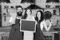 Friendly family in kitchen. cooking healthy food at home. kid chef with her parents. dad and mom teaching daughter how Royalty Free Stock Photo