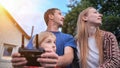 A friendly family launches a drone and controls it through the control panel.