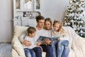 Friendly family reading book on Christmas evening Royalty Free Stock Photo