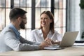 Bank worker with customer sitting at desk in office Royalty Free Stock Photo