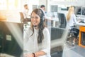 Friendly female call center operator working in office. Royalty Free Stock Photo