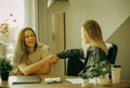 Friendly female colleagues having good relationships, pleasant conversation at workplace during coffee break Royalty Free Stock Photo