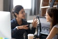 Friendly female colleagues are having pleasant conversation Royalty Free Stock Photo