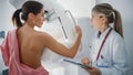 Friendly Female Doctor Explains the Mammogram Procedure to a Topless Adult Female Patient Undergoi Royalty Free Stock Photo