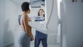 Friendly Female Doctor Explains the Mammogram Procedure to a Topless Latin Female Patient with Cur Royalty Free Stock Photo