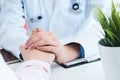 Friendly female doctor hands holding patient hand sitting at the desk for encouragement, empathy, cheering and support Royalty Free Stock Photo