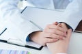 Friendly female doctor hands holding patient hand sitting at the desk for encouragement, empathy, cheering and support Royalty Free Stock Photo