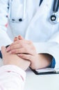 Friendly female doctor hands holding patient hand sitting at the desk for encouragement, empathy, cheering and support Royalty Free Stock Photo