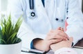 Friendly female doctor hands holding patient hand sitting at the desk for encouragement, empathy, cheering and support Royalty Free Stock Photo