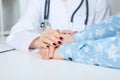 Friendly female doctor`s hands holding male patient`s hand for encouragement and empathy. Partnership trust and medical Royalty Free Stock Photo