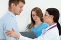 Friendly female doctor touching male patient's arm for encourage Royalty Free Stock Photo