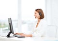 Friendly female helpline operator with computer Royalty Free Stock Photo